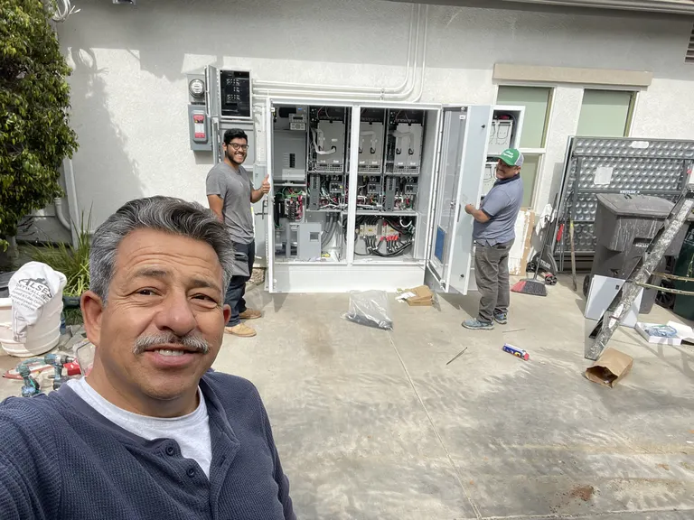 SolarCCS crew installing a battery cabinet system